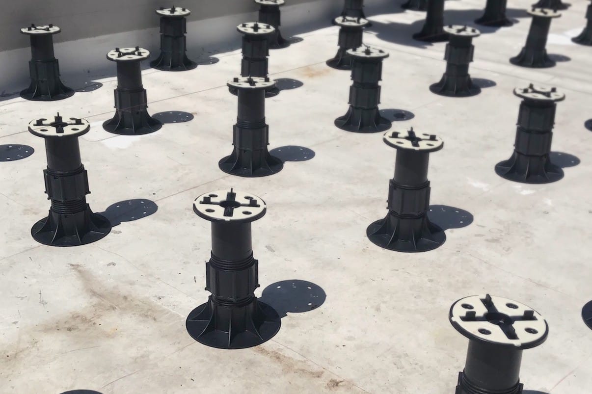 Pedestal supports ready to install on a flat roof.