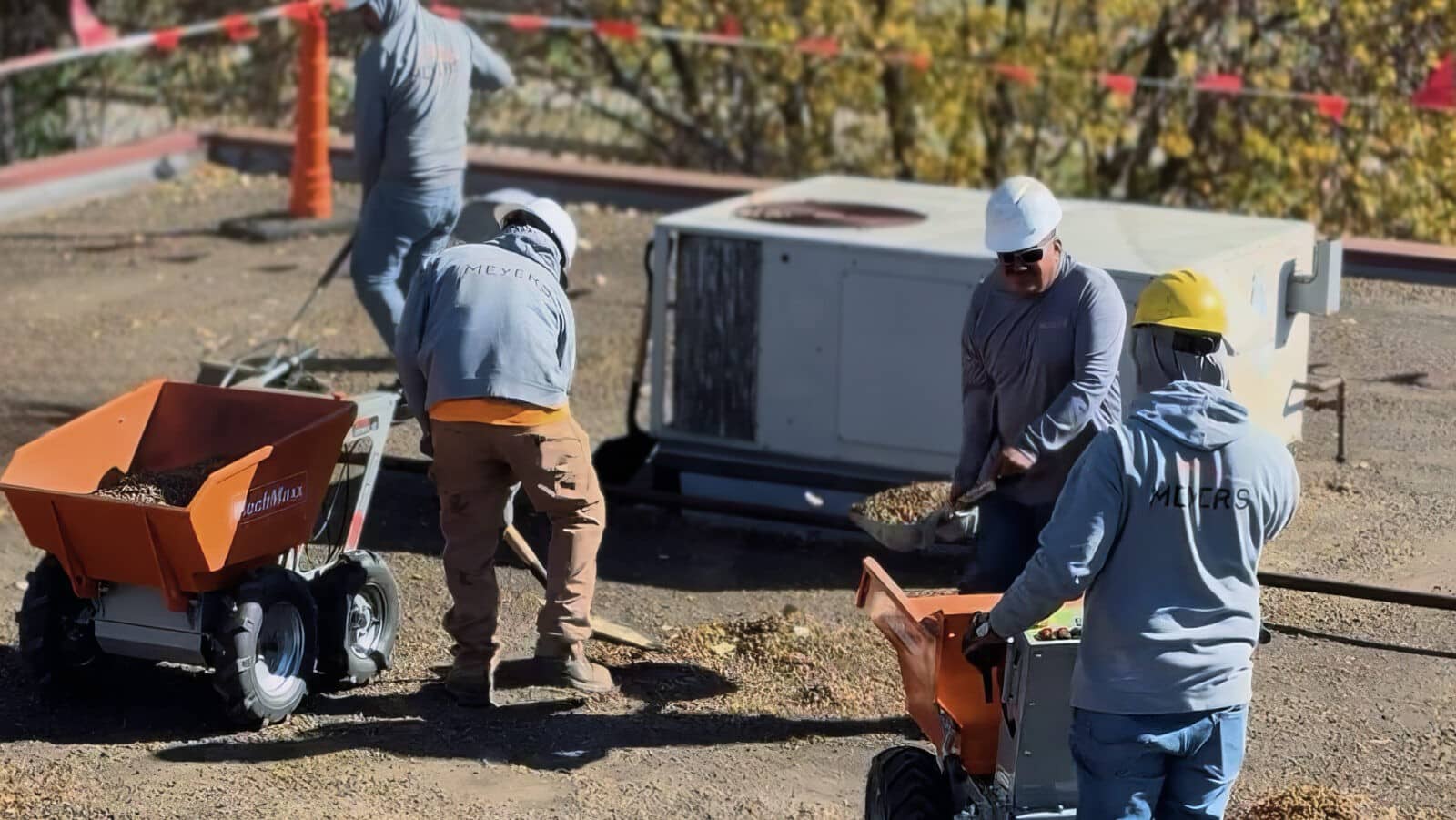 Meyers crew members clean up a flat roof.