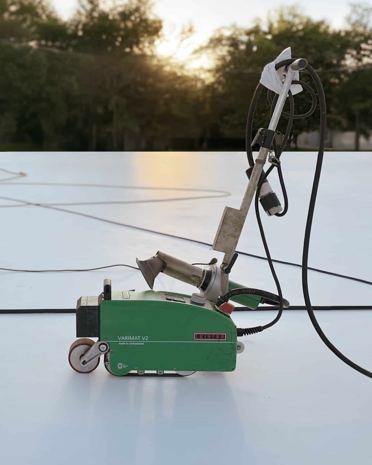 A lone Varimat sits on a rooftop at sunset.