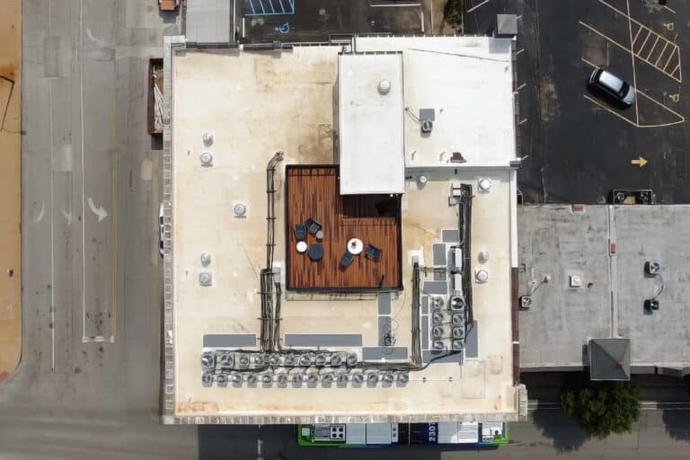 Flat roof with a patio in the middle and HVAC equipment.